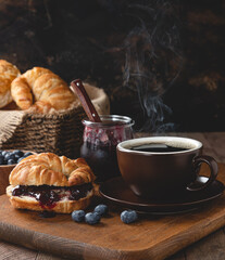Croisant With Blueberry Jam and Cup of Coffee