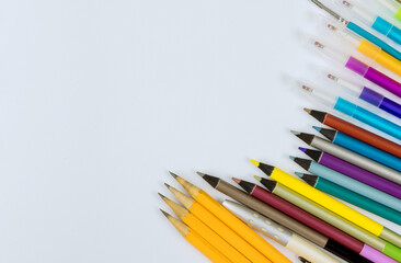 A different colored stationery in stands on a variety school supplies