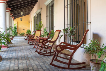 Fototapeta na wymiar Colonial porch with rocking chairs in Cuba