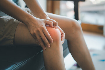 Young woman having knee pain.