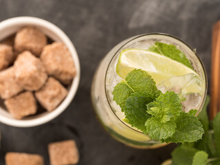 Refreshing mint cocktail mojito with rum and lime, cold drink or beverage with ice on black...