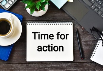 TIME FOR ACTION text on notebook with laptop, cup coffee, green plant, pen and eyeglasses on a wooden background. Flat lay.