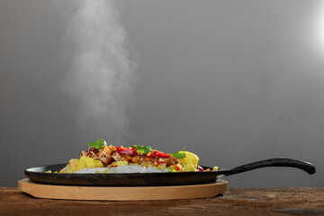 steaming hot sizzler on wood