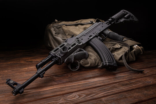 Soviet carbine in modern body kit. Weapons of Russia and the Soviet Union. Classic Soviet AK machine gun on a wooden back