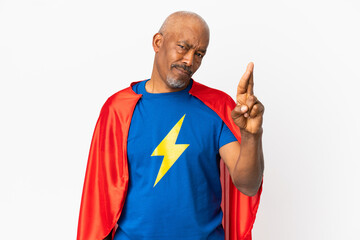 Super Hero senior man isolated on white background with fingers crossing and wishing the best © luismolinero