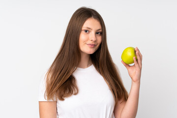 Teenager caucasian girl isolated on white background with an apple