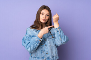 Teenager caucasian girl isolated on purple background making the gesture of being late