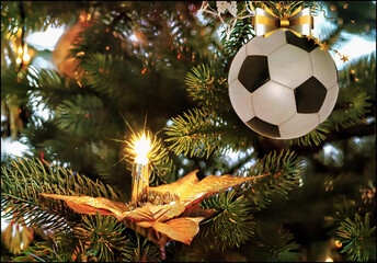 Soccer christmas bauble hanging on the fir branch. Christmas greeting