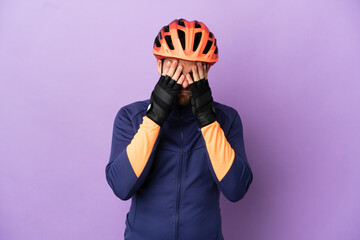 Young Brazilian cyclist man isolated on purple background with tired and sick expression - obrazy, fototapety, plakaty