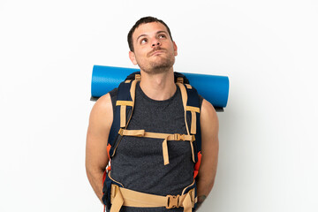Brazilian mountaineer man with a big backpack over isolated white background and looking up