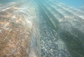 Ruins of ancient column and construction blocks of antique city Hierapolis, in Pamukkale, Turkey under water.