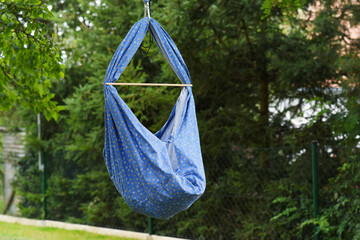 Blue hammock for baby in natural background. Europe. Czech Republic.