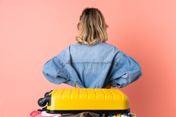 Teenager woman with salad isolated on blue background in back position