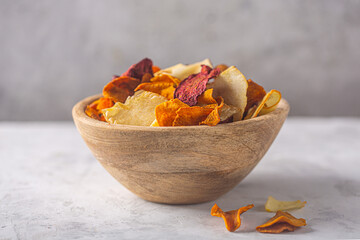 Wooden bowl with organic vegetable dehydrated chips