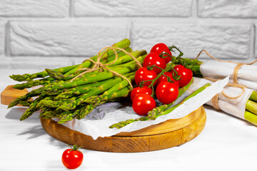 Asparagus and Tomato. Fresh harvest, traditional italian cuisine and foods. Healthy vegetarian food. Fresh raw organic vegetables, market. Vegan backdrop