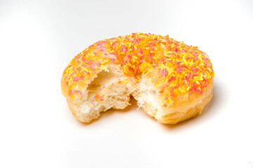 An Iced Ring Donut On A White Background With A Bite Taken Out