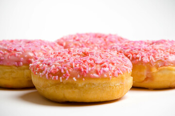 Four Iced Ring Donuts On A White Background