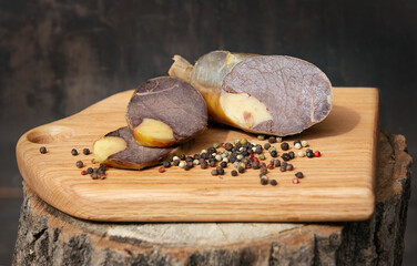Smoked sausage cutaway on the wooden board