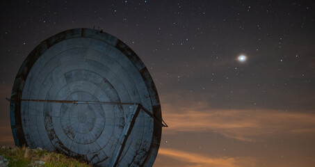 NATO satellite dishes with starry sky and planet Jupiter