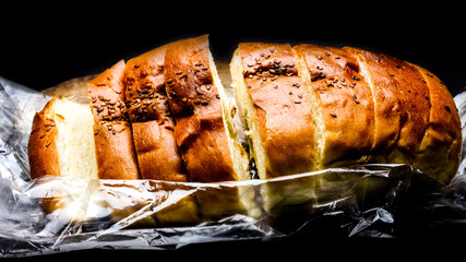 Homemade soft roasted bread close up view on dark background