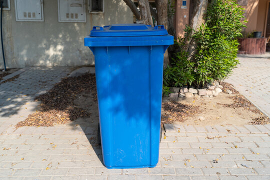 Large blue wheelie dustbin in the community area.