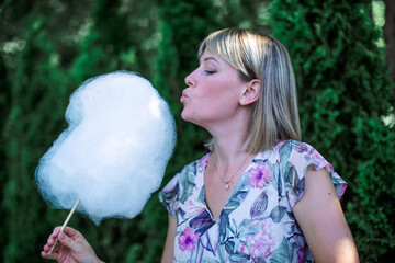 blonde woman eating cotton candy