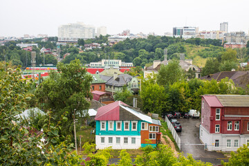 Top panoramic top view of the roofs of the historic buildings of the old city and the lush green foliage of trees on a cloudy summer day in Vladimir