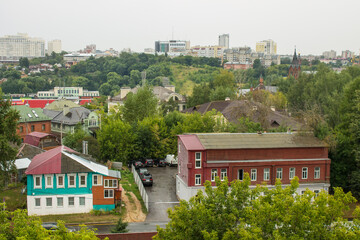 VLADIMIR, RUSSIA-AUGUST, 11, 2021: panoramic top view of the roofs of the historic buildings of the old city and the lush green foliage of trees on a cloudy summer day
