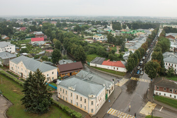SUZDAL, Vladimir Region, RUSSIA-August, 11,2021: panoramic view of the old town with the roofs of historical buildings and the green foliage of trees on a cloudy summer day
