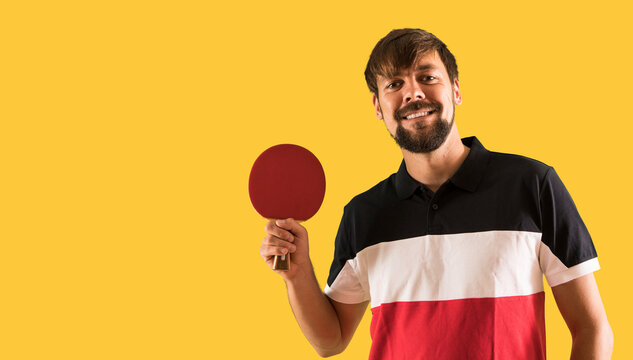 Portrait of happy male athlete playing table tennis - Powered by Adobe