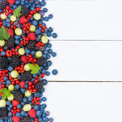 Naklejka na ściany i meble Berries fruits berry fruit strawberries strawberry blueberries blueberry with copyspace copy space square on wooden board