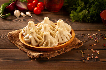 Traditional Georgian dish, khinkali Kalakuri, on a wooden table, rustic, top view, no people,...