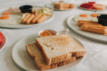 Hotel complimentary breakfast sets served on white bed.