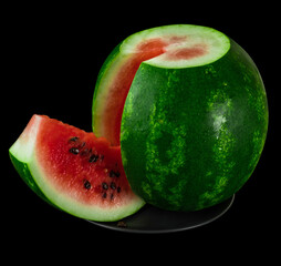 Watermelon with cut discount on black plate on black background isolated