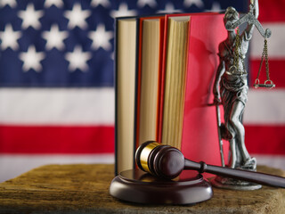The judge's gavel, a statue of justice, books on the background of the American state flag. It symbolizes justice, the Constitution, a fair sentence, equality of law. Lots of facilities.