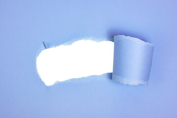 Blue torn paper whole with copyspace