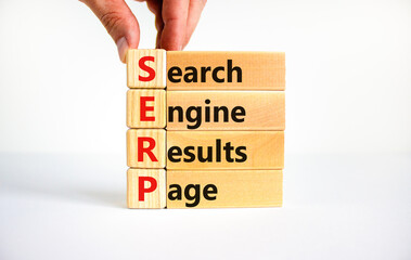 SERP symbol. Abbreviation SERP search engine results page on wooden blocks. Beautiful white...