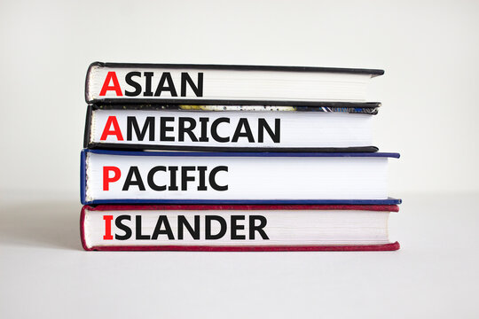 AAPI symbol. Abbreviation AAPI asian american pacific islander on books. Beautiful white background. Copy space. Business and AAPI asian american pacific islander concept.