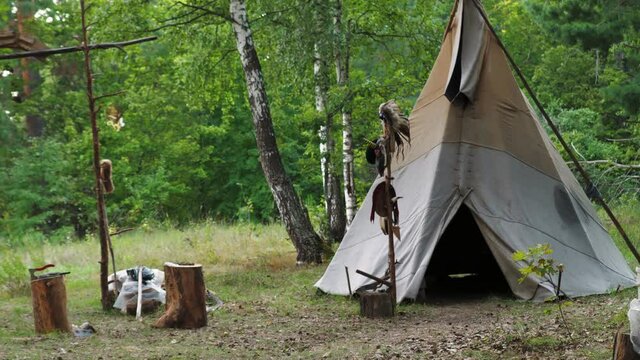 Forest home of the Indians. Wigwam indian teepee. The life of nomadic tribes. The wigwam stands in the forest. A hut of nomadic peoples. A home of Indians. tippi aka in the forest.