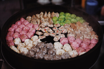 Close up details of Asian street food: grilling meatballs