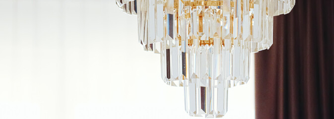 Crystal glass chandelier with golden details, luxury furniture and home decor concept