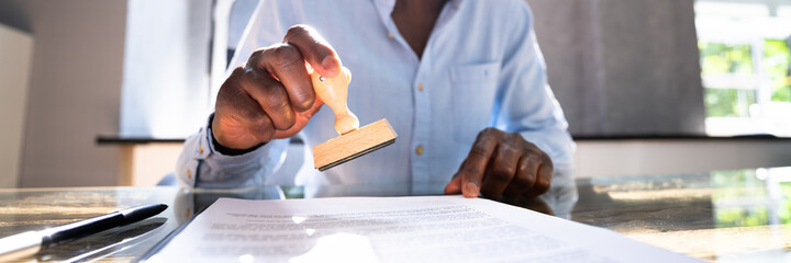 African American Black Man Using Notary Stamp