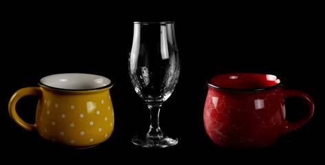 Empty wine glass and traditional coffee mug, cup isolated on black background with clipping path
