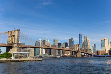 Fototapeta na wymiar Cityscape of Brooklyn Bridge and Lower Manhattan skyscraper from beach of Brooklyn Bridge Park on June 18, 2021 in Brooklyn New York City.