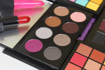 Brightly Colored Cosmetic Pigment Palettes With Various Cosmetics