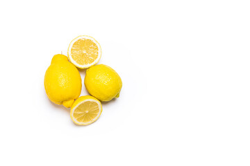 Overhead photograph of two lemons and a lemon in two halves on a white background.The photo is shot in horizontal format and has space to write text.