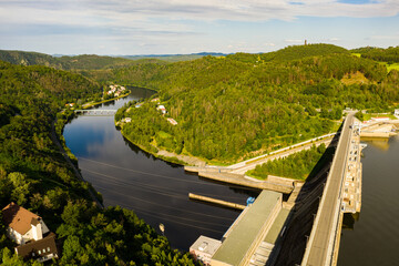 The Orlik Reservoir on Vltava River is largest hydroelectric dam in Czech Republic. Aerial view to important source of sustainable energy in European Union. - obrazy, fototapety, plakaty