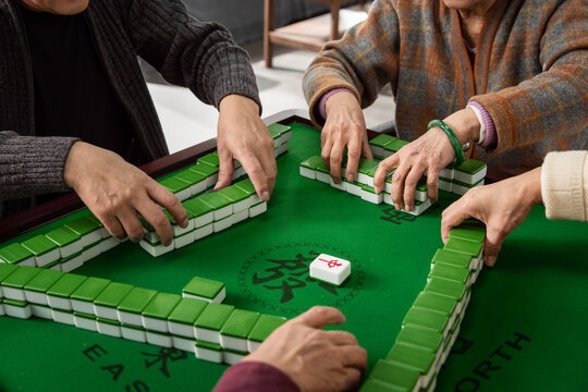 Happy old people playing mahjong
