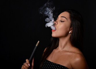 Beautiful  and sexy girl smokes hookah, sheesha. Sexy woman smoking. The pleasure of smoking.
