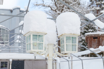 Fototapeta na wymiar White vintage lanterns covered by snow